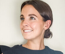 stuart pennebaker.jpeg - Experience Camden, South Carolina Portrait of a smiling woman with dark hair tied back, wearing a dark blue top, looking to her left.