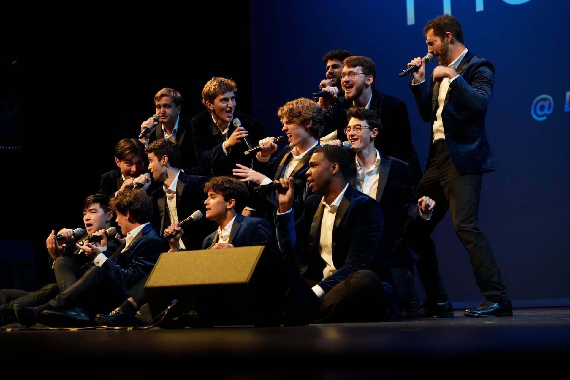 pitchforks 2025 - Experience Camden, South Carolina The Duke University Pitchforks, a male a cappella group in suits performing on stage with microphones.